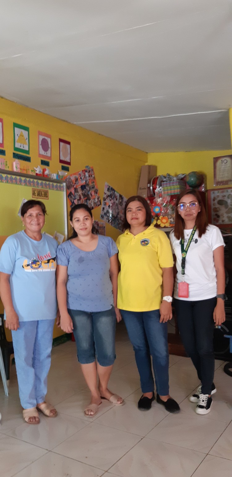 Mary Ann Matilla (2nd from left) and barangay health workers